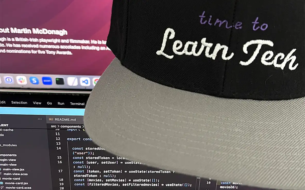 a coding workspace, including a laptop showing a README file, a monitor showing movie details, and a cap which says time to learn tech
